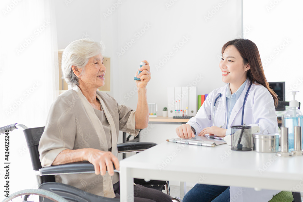 old asian female training to use inhaler medicine, asian doctor explain about how to use inhaler medicine, asthma clinic, elderly disease