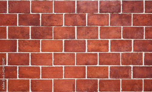 old wall made of red bricks creating a pattern 