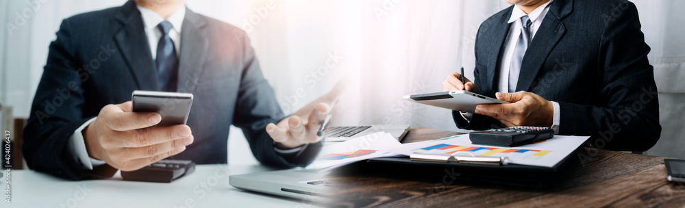 Healthcare costs and fees concept.Hand of smart doctor used a calculator for medical costs in modern hospital Healthcare costs and fees concept.Hand of smart doctor used a calculator for medical costs in modern hospital
