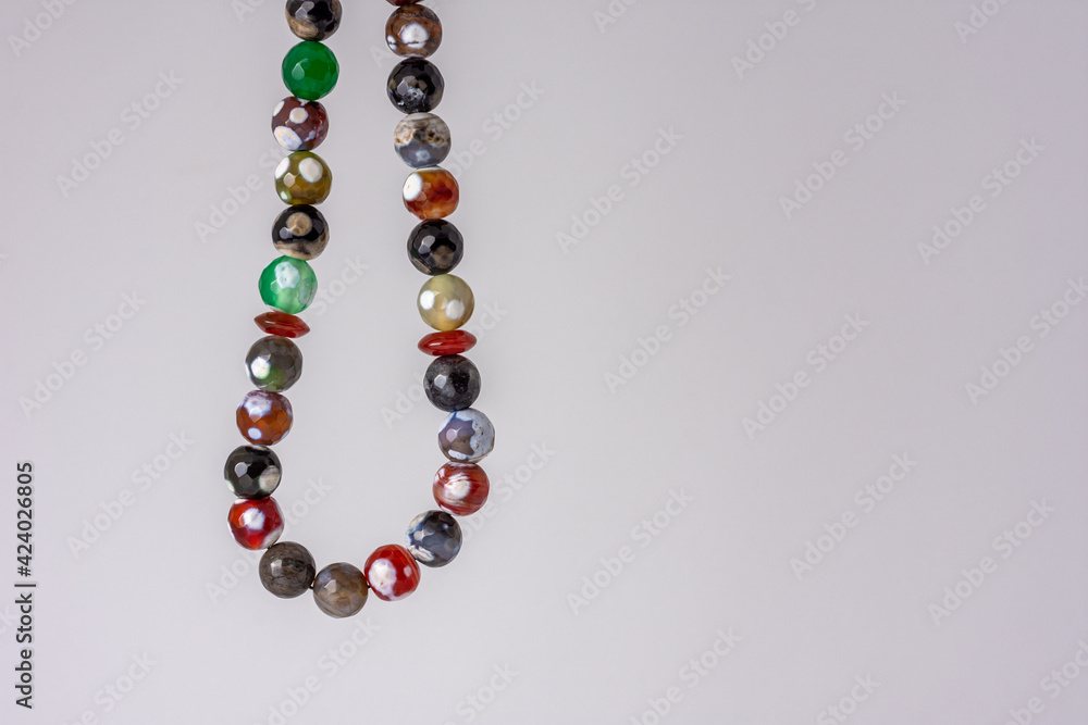Close up colorful men's Muslim Prayer beads hanging on white background, Ramadan concept Close up colorful men's Muslim Prayer beads hanging on white background, Ramadan concept