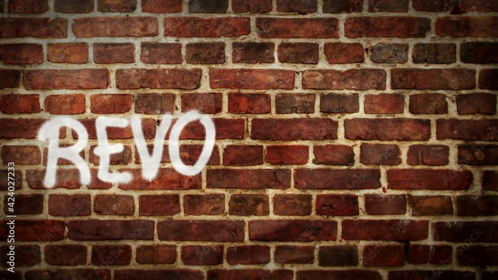 Revolution spray painted on the brick wall. Graffiti art concept message. Airbrush hand paint. City abstract artwork. Revolution spray painted on the brick wall. Graffiti art concept message. Airbrush hand paint. City abstract artwork.