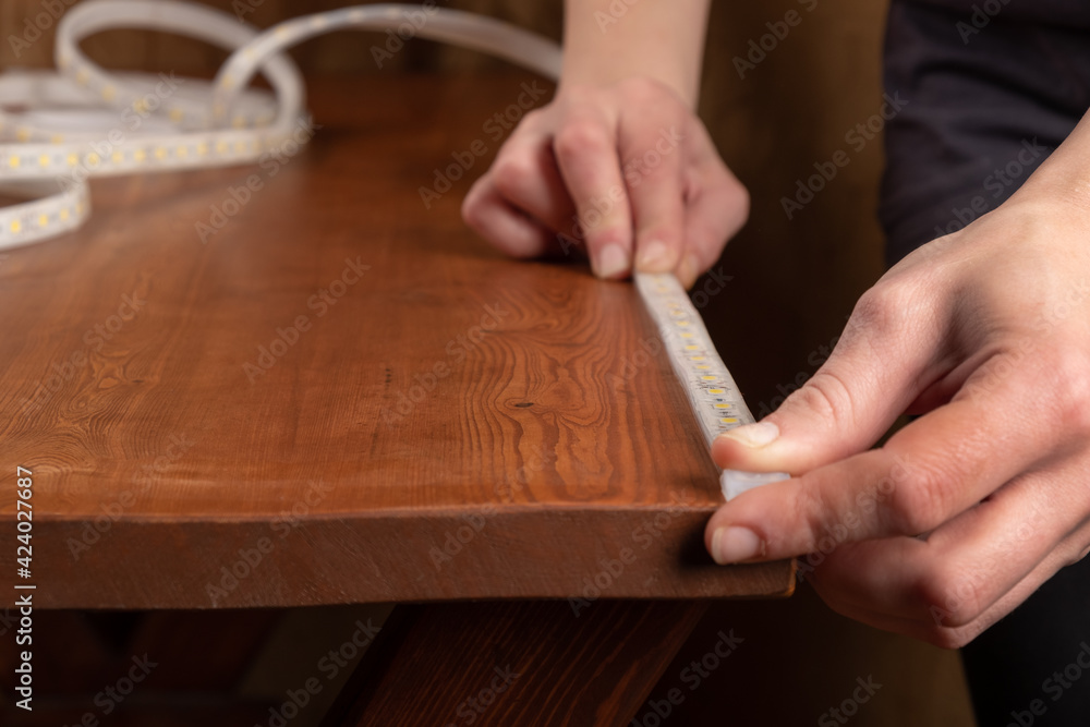 LED strip installation,adhesive diode tape is attached to the table LED strip installation,adhesive diode tape is attached to the table