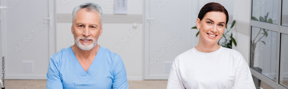 smiling rehabilitologist and pretty patient looking at camera, banner smiling rehabilitologist and pretty patient looking at camera, banner