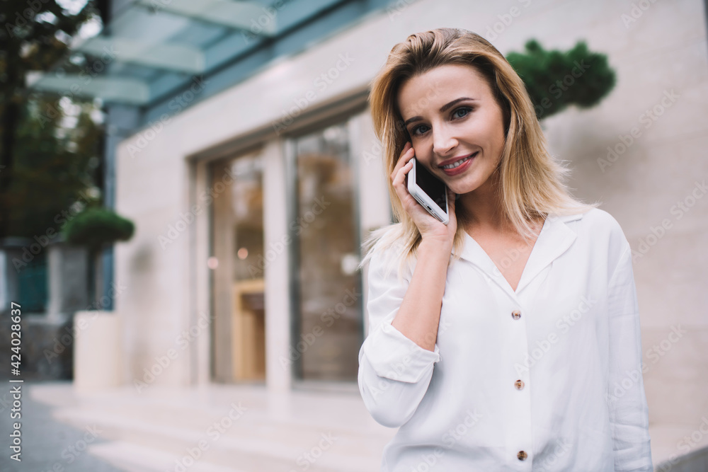 Content female calling on smartphone on street at daytime Content female calling on smartphone on street at daytime