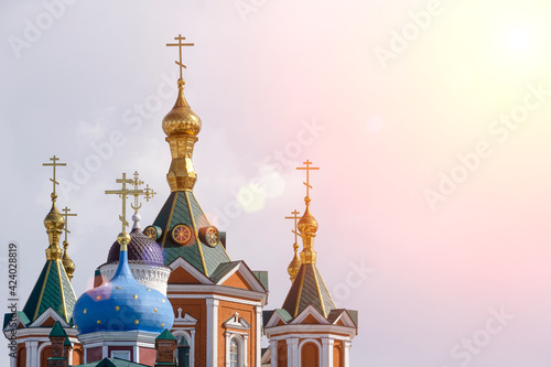 Russian Christian Orthodox church with domes and a cross against the sky. Russian Orthodoxy and Christian Faith concept.