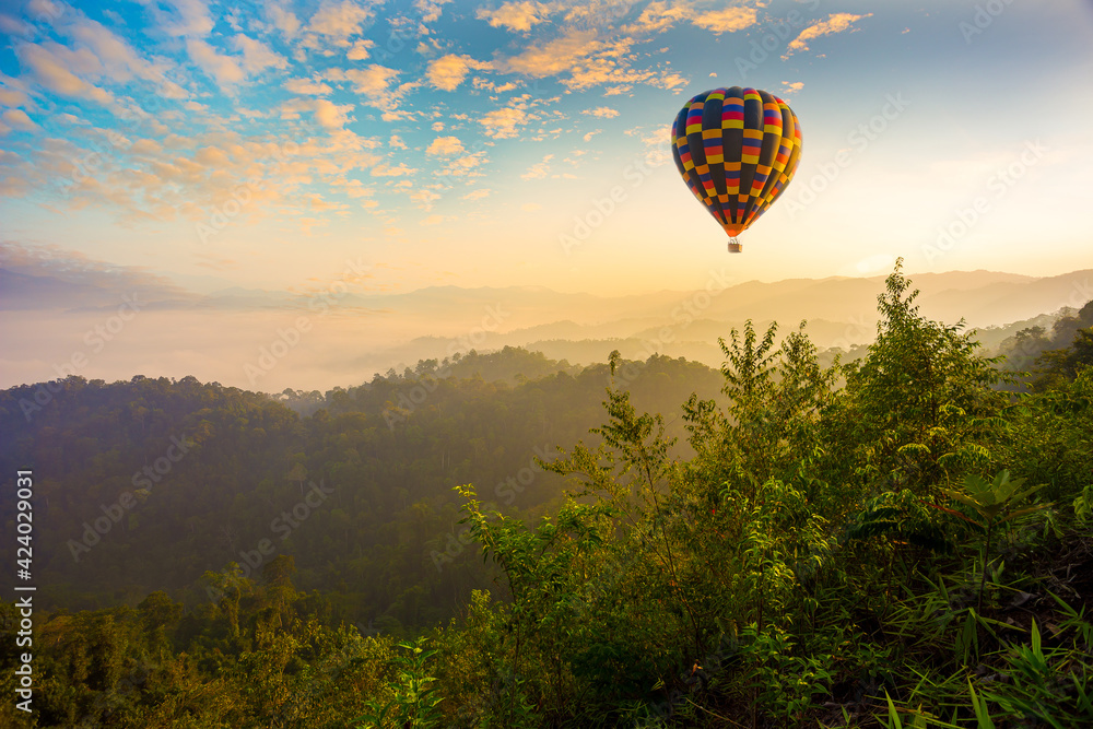 Colorful hot-air balloons flying over the mountain,Doi Inthanon National park in the sunrise and main road at Chiang Mai Province, Thailand