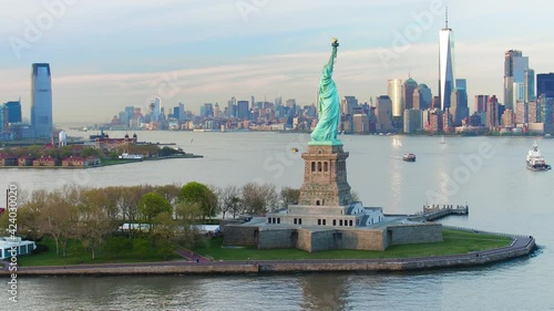 Statue of Liberty at dusk aerial view. Manhattan and New Jersey skyline. New York City, United States. Shot from a helicopter.