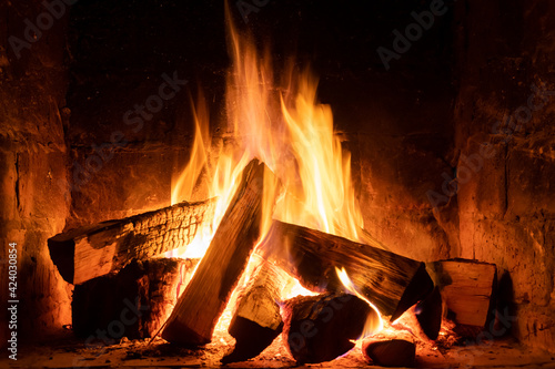 A fire burns in a fireplace, Fire to keep warm