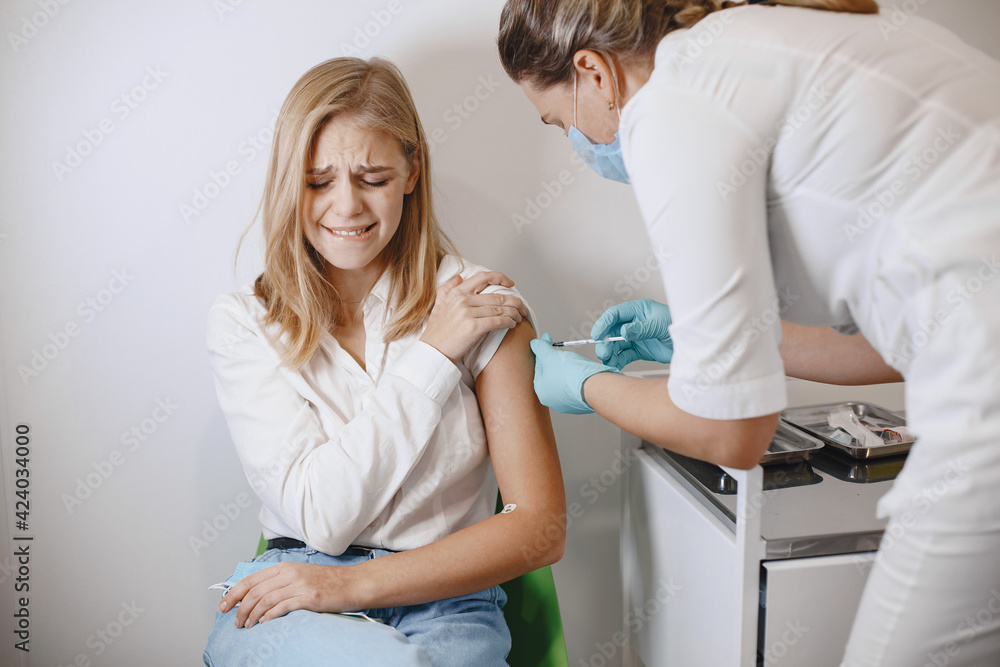 Fototapeta premium Woman doctor gives a vaccine to patients