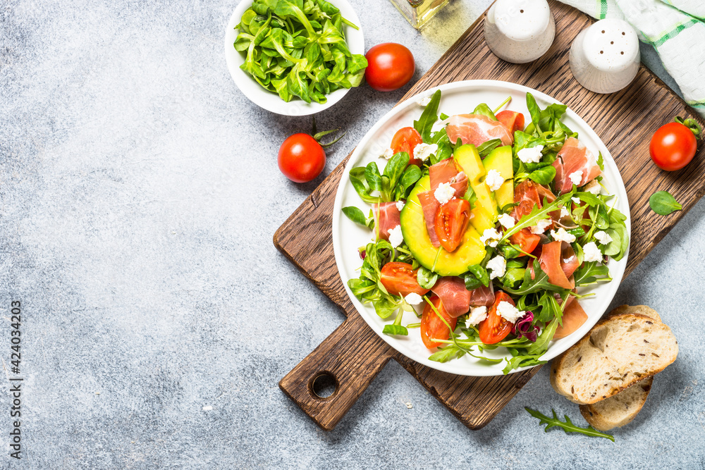 Fresh salad with green leaves, jamon and tomatoes. Fresh salad with green leaves, jamon and tomatoes.