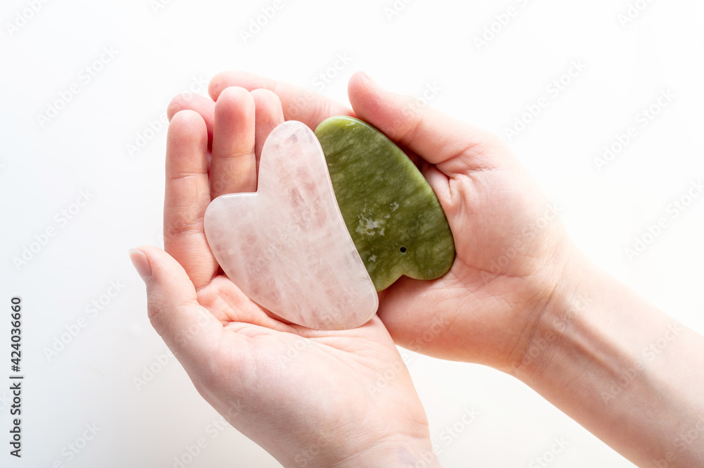 Heart-shaped massage stones. Two heart-shaped stones in the palms. Gentle massage of the face and body. Heart-shaped massage stones. Two heart-shaped stones in the palms. Gentle massage of the face and body.