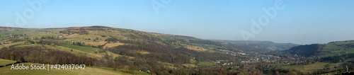 panoramic view of the calder valley in west yorkshire with the town of mytholmroyd surrounded by fields, woods and moorland