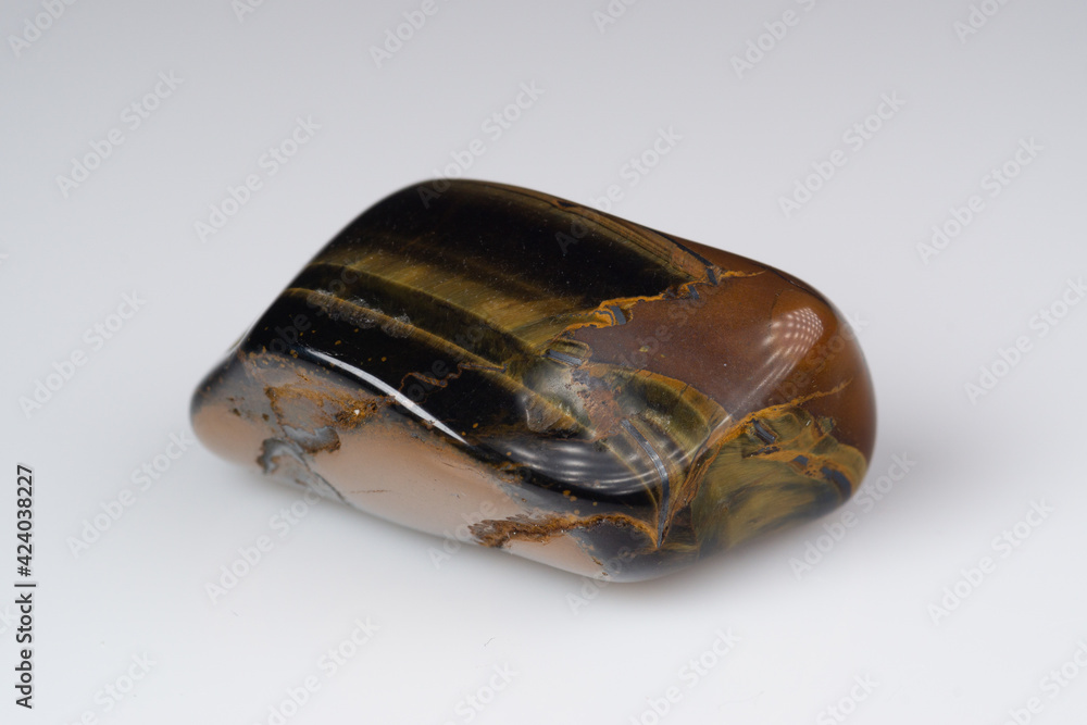 Natural gem tiger's eye on a white background Natural gem tiger's eye on a white background