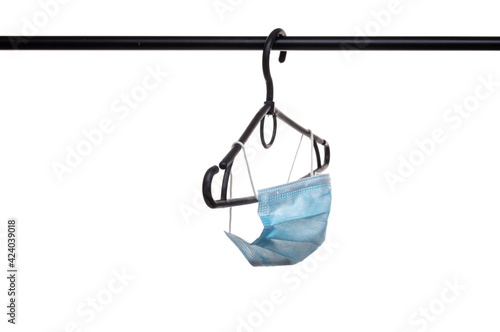 Medical mask hanging on clothes hangers. Medical mask isolate. Side view of the mask.