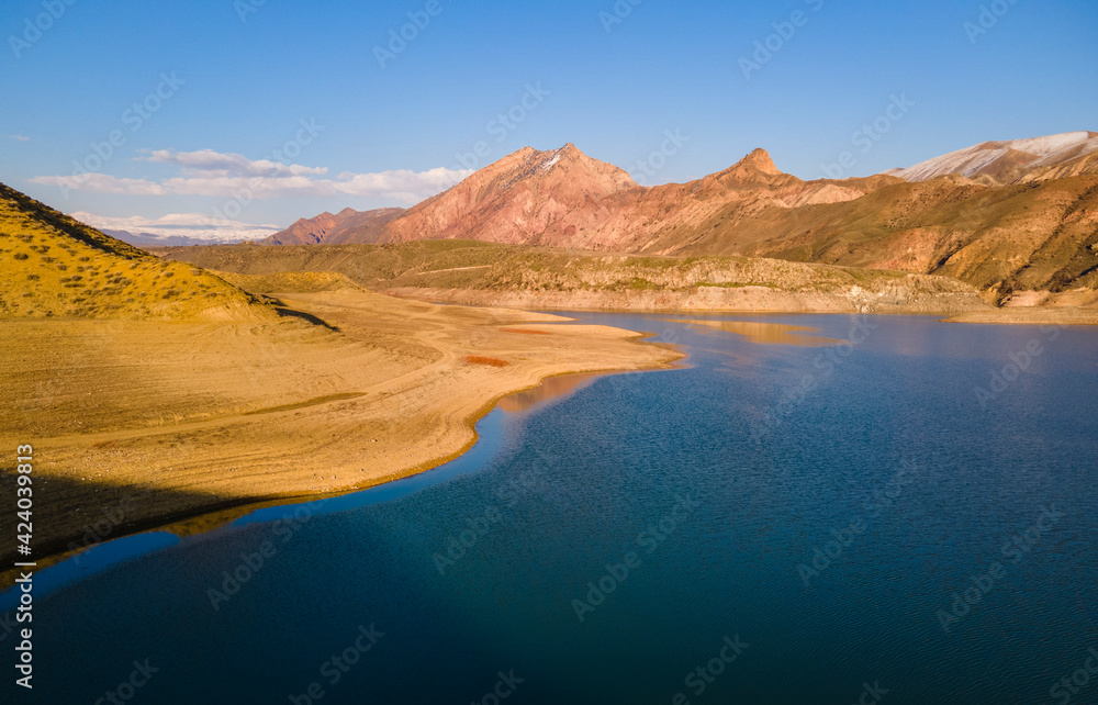 Panoramic aerial view on the  lake and mountains at the bright sunny day. Beautiful landscape.