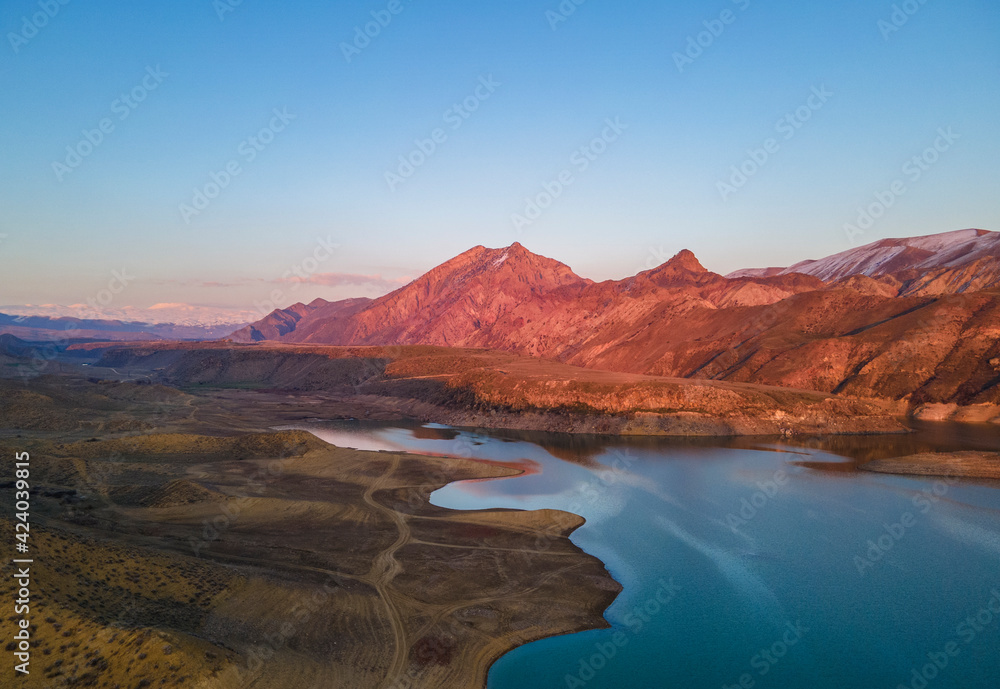 Panoramic aerial view on the  lake and mountains at the sunset. Beautiful landscape.
