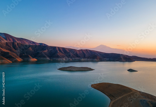 Panoramic aerial view on the lake and mountains at the sunset. Beautiful landscape.