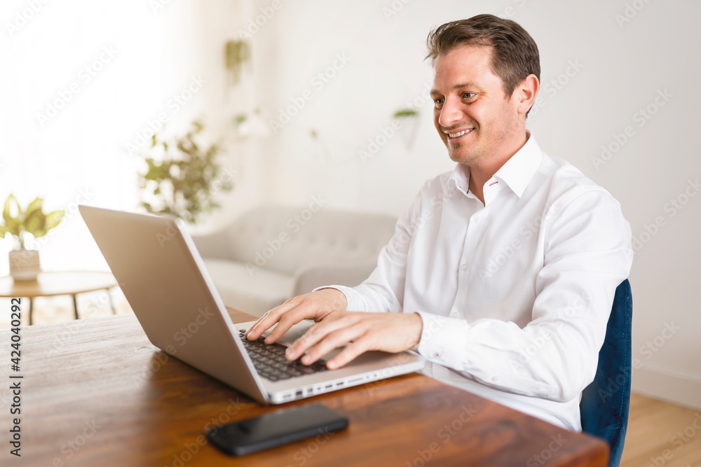 businessman working on laptop online sitting at kitchen table businessman working on laptop online sitting at kitchen table