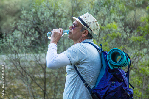 tired hiker or pilgrim stopping to rest and drink