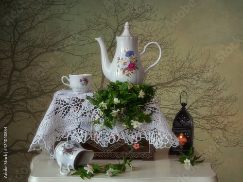 Spring evening with tea table and wildflowers photo