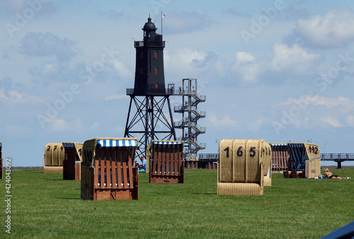 Strandkoerbe und Leuchtturm in Dorum-Neufeld photo