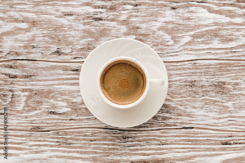 Cup of coffee espresso on wooden table, top view