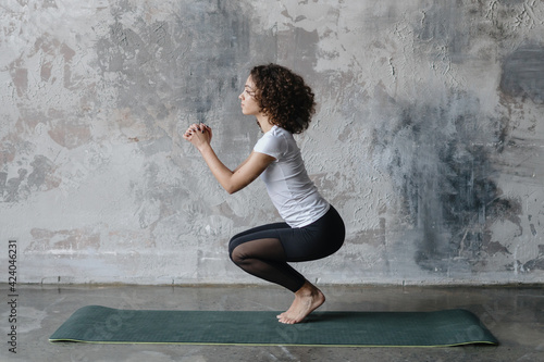 African american woman doing sport training on exercise mat