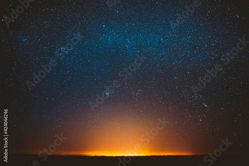Awe Beautiful Night Sky Glowing Stars Background Backdrop With Colorful Sky Gradient. Sunset Sunrise Light And Colourful Night Starry Sky In Blue Yellow Orange Colors.
