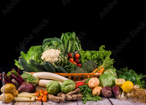 Fototapeta Naklejka Na Ścianę i Meble -  Variety of vegetables carrot beans cabbage capsicum basket blackdrop