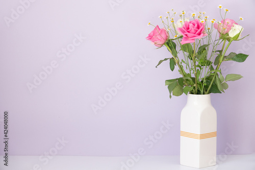 Rose placed on the desk in blue background