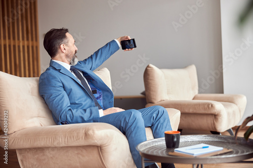 Happy adult caucasian man is working in a modern office