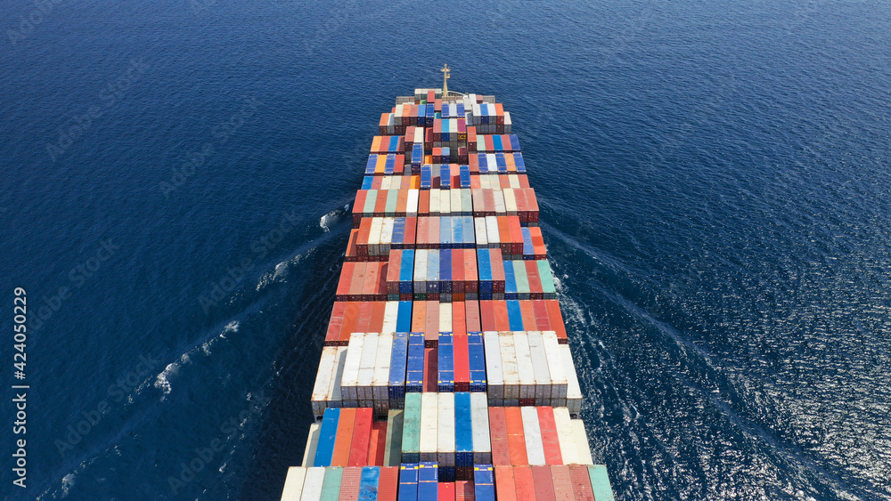 Fototapeta premium Aerial drone photo of container cargo ship in import export business commercial trade logistic and transportation in the open sea, Container cargo freight shipping.