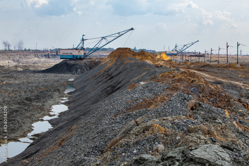 Rudny/Kazakhstan - May 14 2012: Walking dragline excavators removing empty rocks in quarry. Extraction iron ore by Open-pit mining Rudny/Kazakhstan - May 14 2012: Walking dragline excavators removing empty rocks in quarry. Extraction iron ore by Open-pit mining