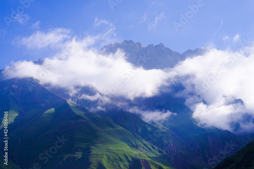 Snow-white clouds on the slopes of the mountains in the vicinity of Ushtulu