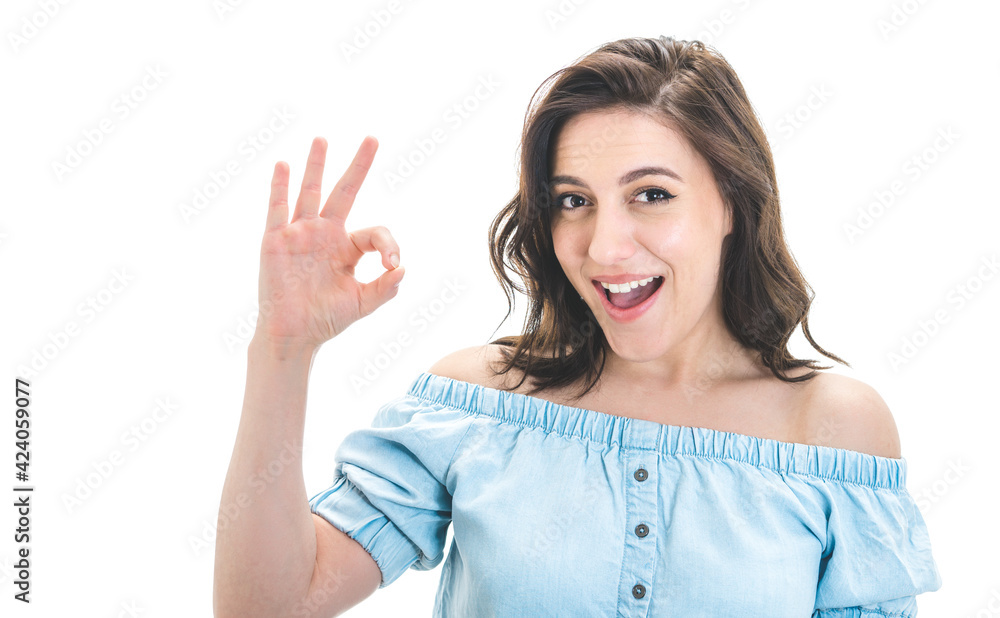 Joyful woman showing excellent sign with finger, isolated on white background. Yes or excellent gesturing, body language concept Joyful woman showing excellent sign with finger, isolated on white background. Yes or excellent gesturing, body language concept