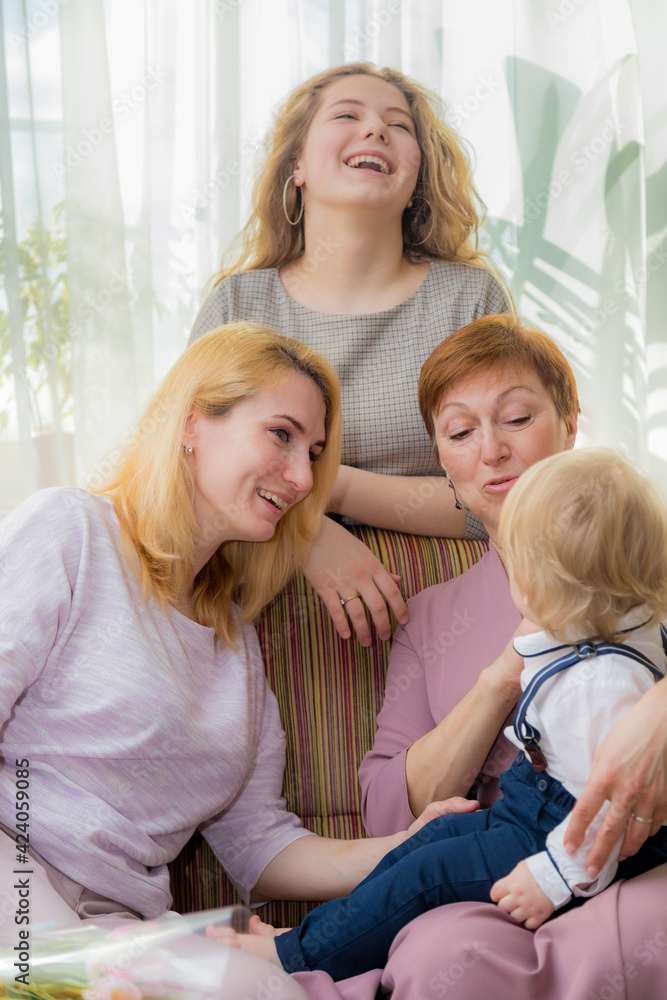 The kid congratulates his mother and grandmother on the holiday The kid congratulates his mother and grandmother on the holiday