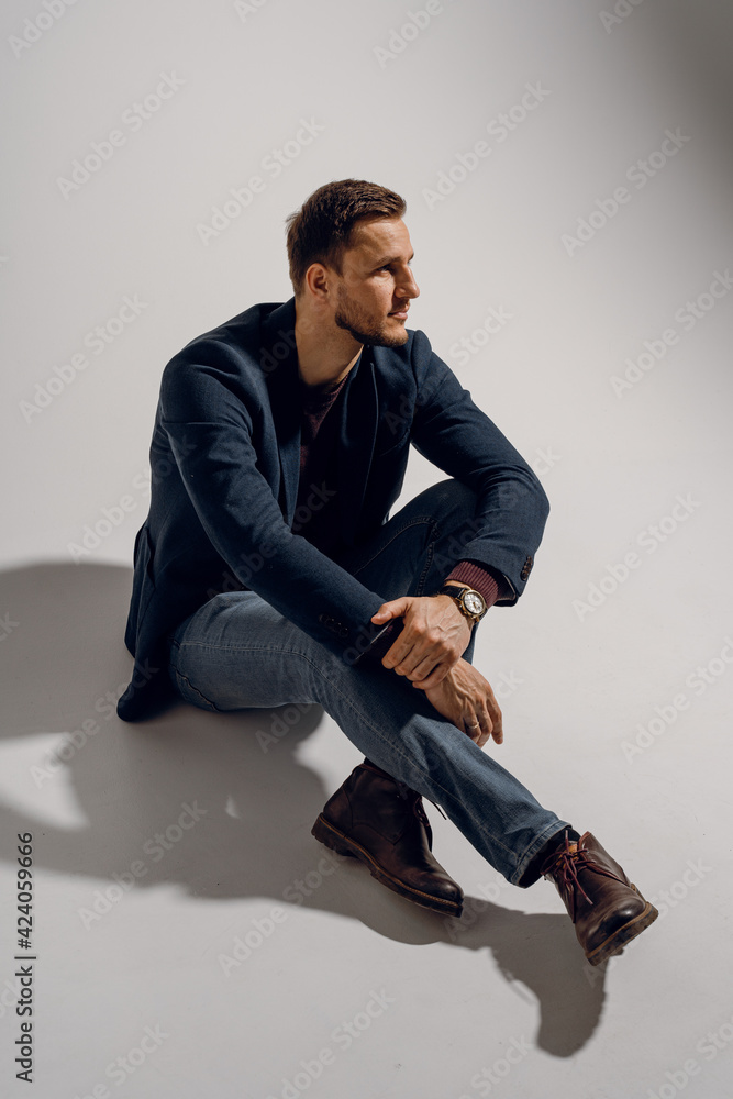 Fashion business man model posing in the studio. Confident male weared casual suit. Fashion business man model posing in the studio. Confident male weared casual suit.