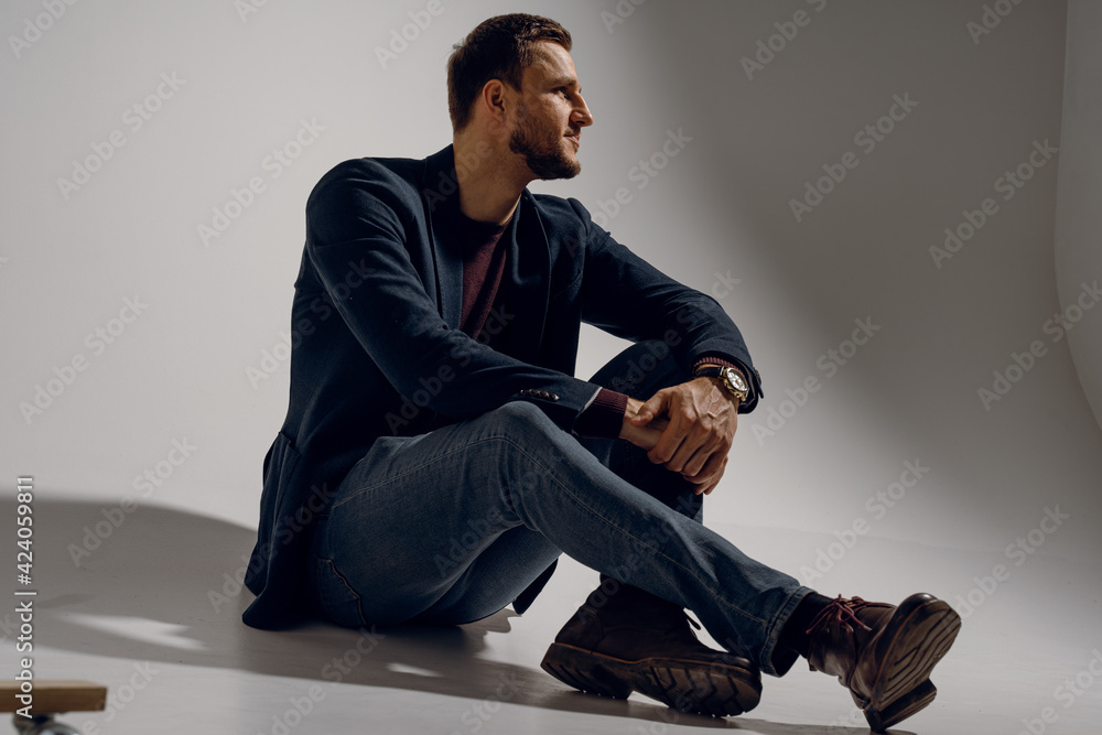 Fashion business man model posing in the studio. Confident male weared casual suit. Fashion business man model posing in the studio. Confident male weared casual suit.
