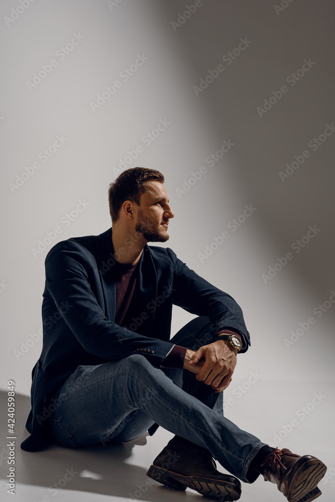 Fashion business man model posing in the studio. Confident male weared casual suit. Fashion business man model posing in the studio. Confident male weared casual suit.