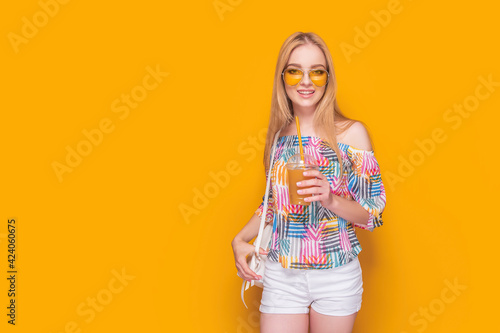 Stylish young woman with drink in summertime