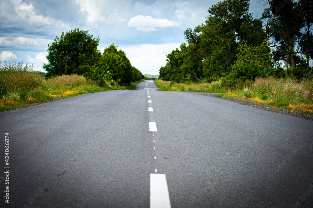 Fototapeta premium Road in the countryside on sunset