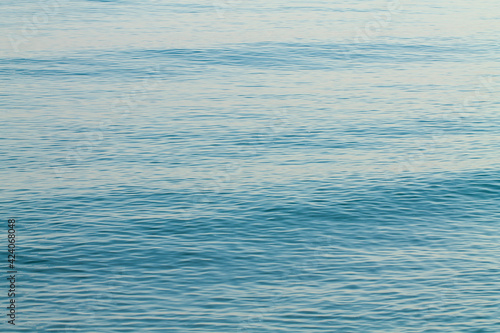 Sea water blue surface with ripples. Abstraction.