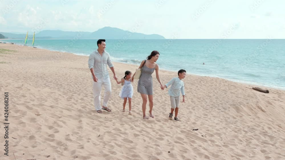 Happy young Chinese family walking on beach,4K Happy young Chinese family walking on beach,4K