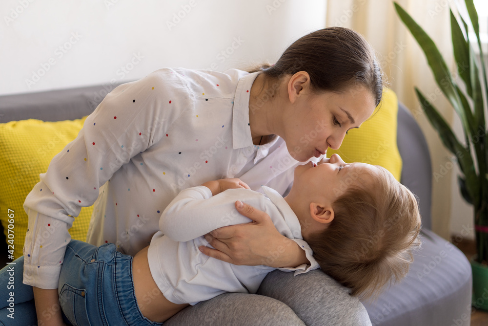 caucasian family little preschool baby boy and mom young woman hug