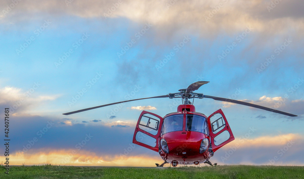  AirBus H125 Helicopter on helipad with clouds in background. - obrazy, fototapety, plakaty 
