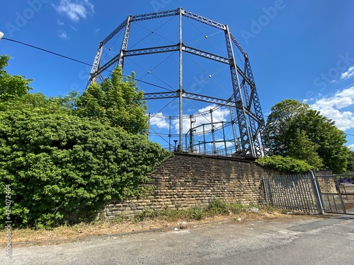 Gas Holder columns, set against a blue sky, on the outskirts of, Keighley, Yorkshire, UK photo