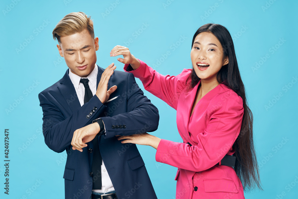 young couple of asian appearance work colleagues in suits modern style young couple of asian appearance work colleagues in suits modern style