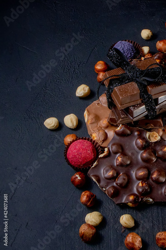 Chocolate bar, crushed pieces of dark chocolate and nuts. Praline Chocolate sweets