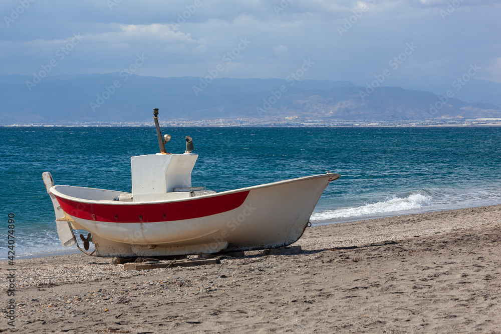 Old fishing boat on the shore of the Mediterranean Sea, Cabo Gata natural park, Almeria, Spain Old fishing boat on the shore of the Mediterranean Sea, Cabo Gata natural park, Almeria, Spain