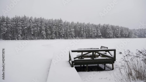 Wallpaper Mural Empty Bench on Wooden Pier with Snowy Forest in Background, Snowing, Slow Motion Torontodigital.ca